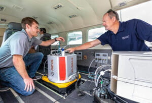 95West Pilot Andrew Werle (left) checks the RIEGL scanner with Aerial Services Manager Miles Strain (right) before takeoff.